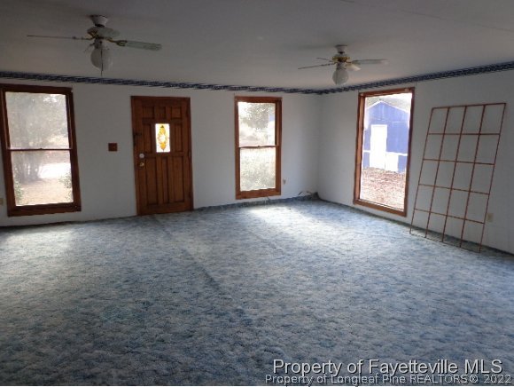 310 Turnpike Road Raeford, NC 28376 - Photo 2 of 6 a view of an empty room with window and cabinet
