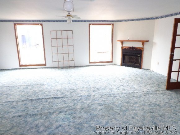 310 Turnpike Road Raeford, NC 28376 - Photo 3 of 6 en empty room with windows and fireplace