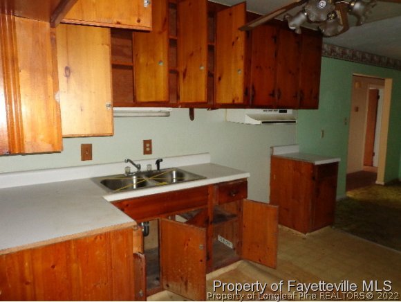 310 Turnpike Road Raeford, NC 28376 - Photo 4 of 6 a kitchen with a sink cabinets and wooden floor
