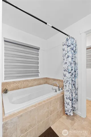 a bathroom with a bathtub and shower