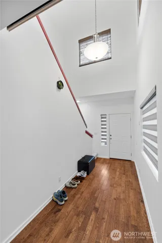 a view of a livingroom with wooden floor and stairs
