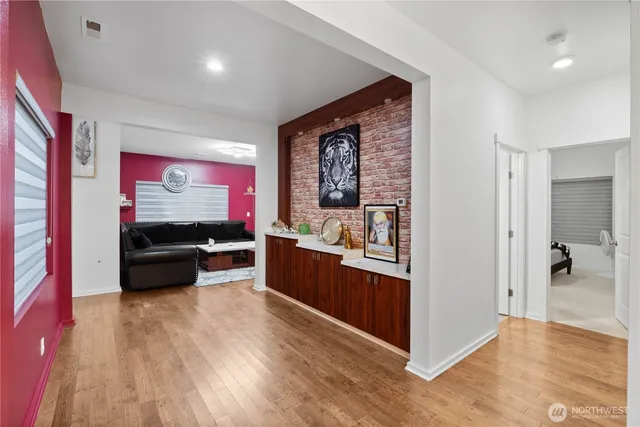 a kitchen with stainless steel appliances kitchen island granite countertop a refrigerator and a sink