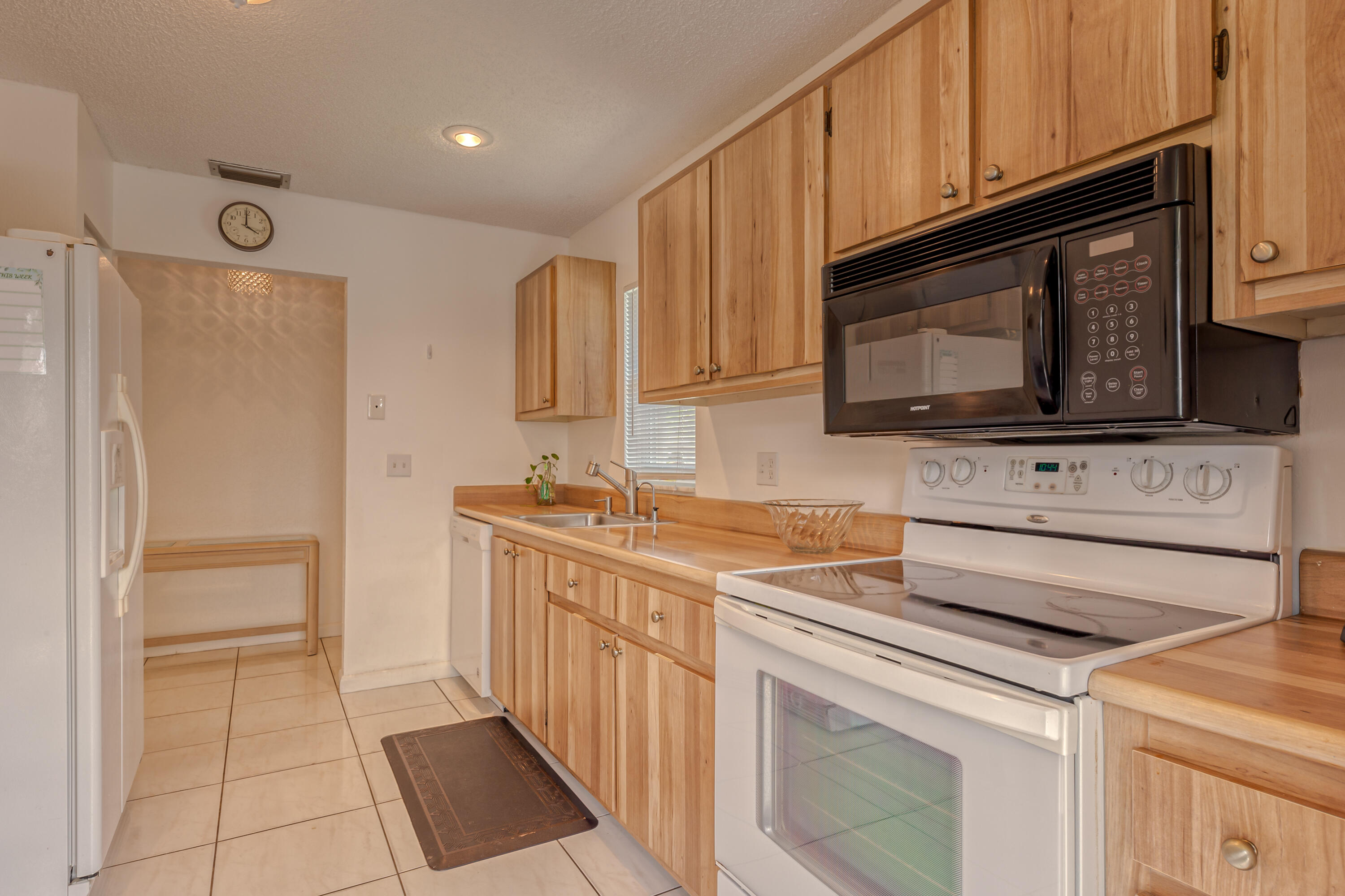 8916 Rheims Road Boca Raton, FL 33496 - Photo 12 of 31 a kitchen with stainless steel appliances granite countertop a stove a microwave and a refrigerator