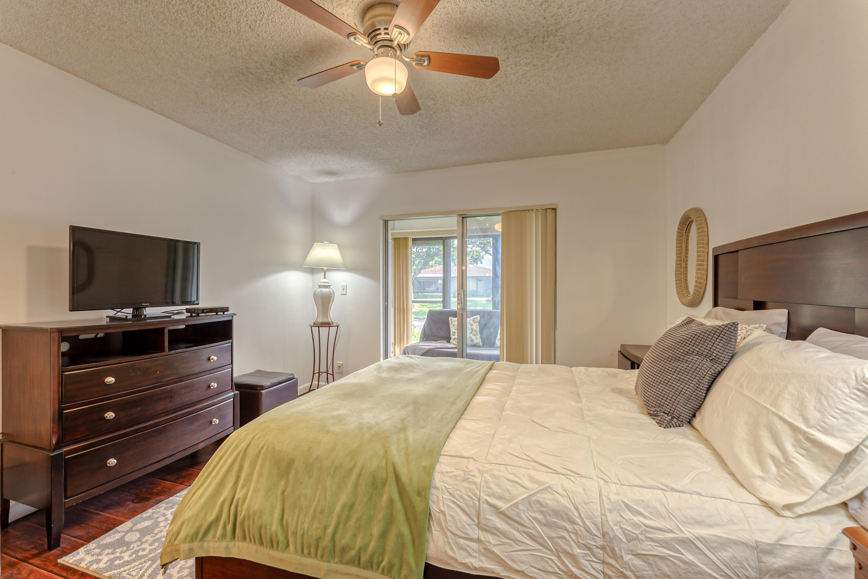 8916 Rheims Road Boca Raton, FL 33496 - Photo 17 of 31 a bedroom with a bed and a flat tv screen on dresser