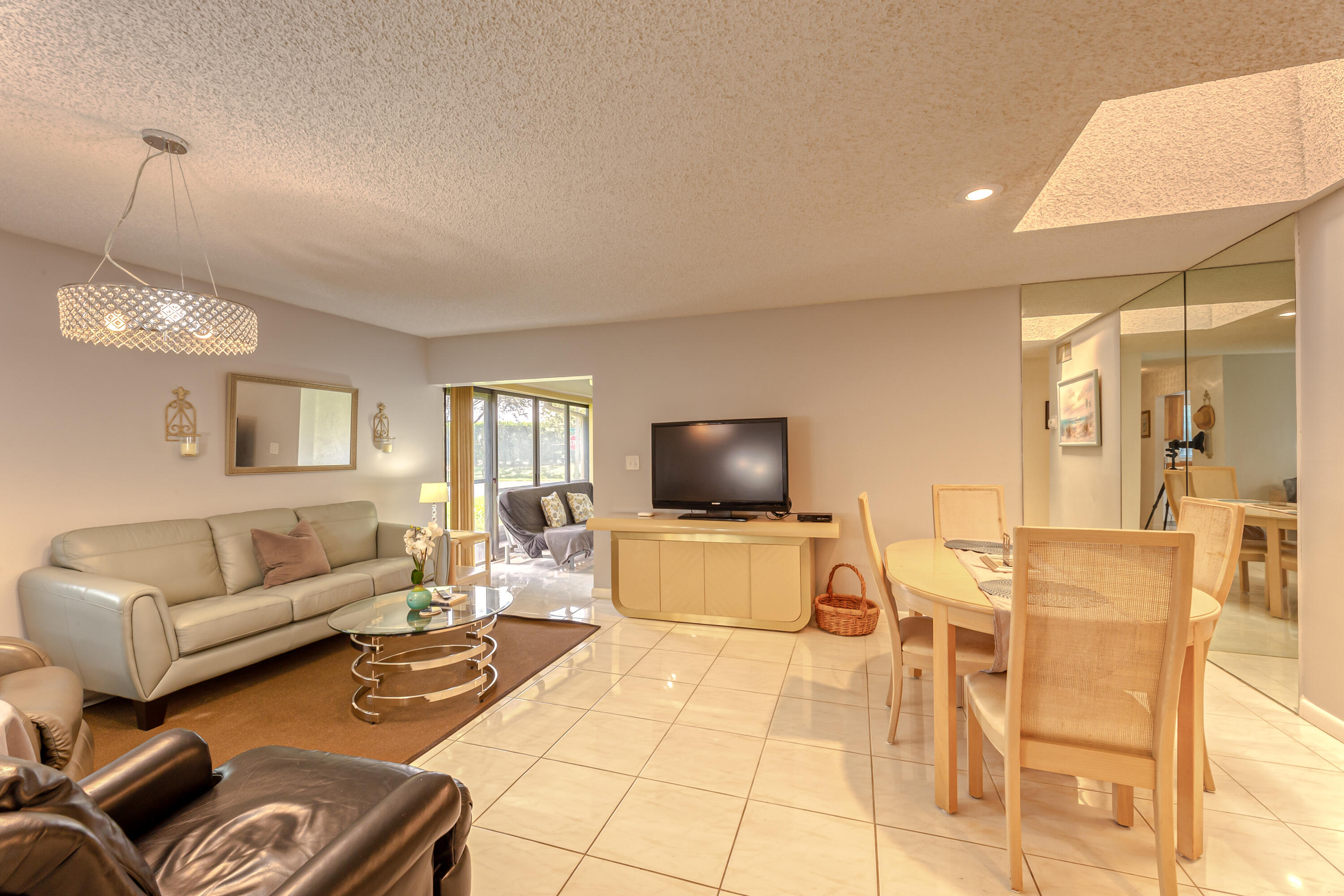 8916 Rheims Road Boca Raton, FL 33496 - Photo 4 of 31 a living room with furniture and a flat screen tv