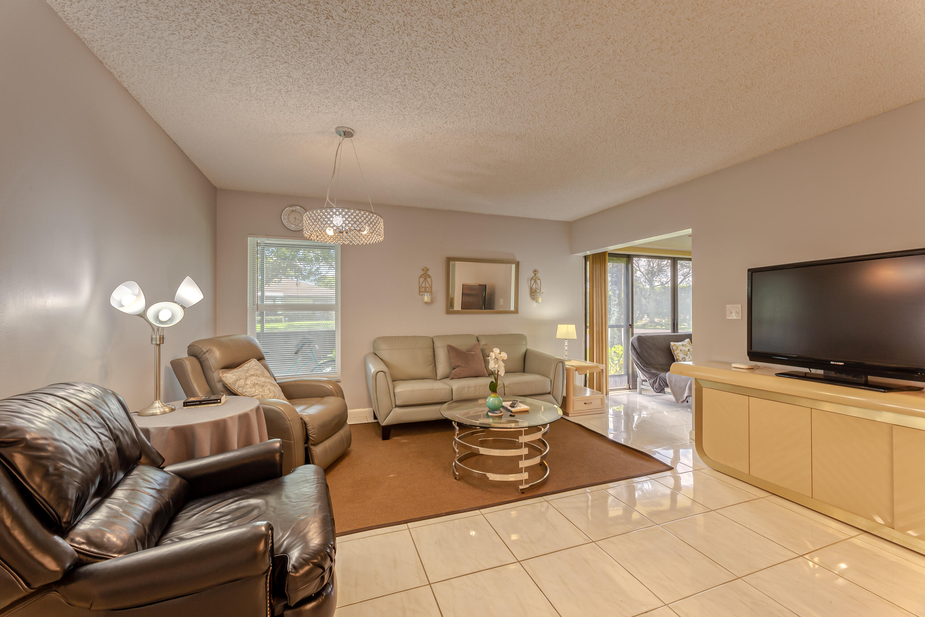8916 Rheims Road Boca Raton, FL 33496 - Photo 5 of 31 a living room with furniture and a flat screen tv