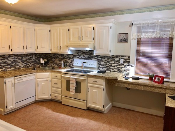 130 Copperfield Road Worcester, MA 01602 - Photo 4 of 32 a kitchen with stainless steel appliances granite countertop a sink stove and cabinets
