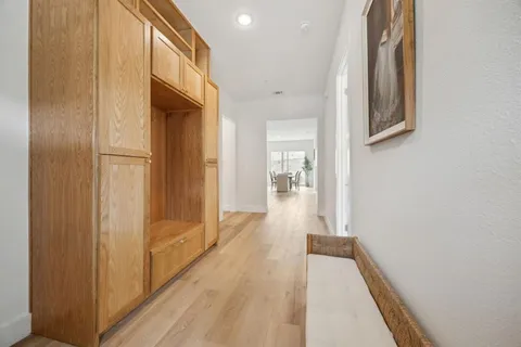 a view of hallway with wooden floor