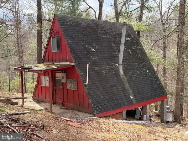 a view of a wooden house with a small yard
