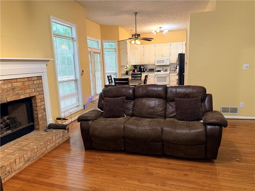426 Pates Lake Court Hampton, GA 30228 - Photo 48 of 60 a living room with furniture and a fireplace