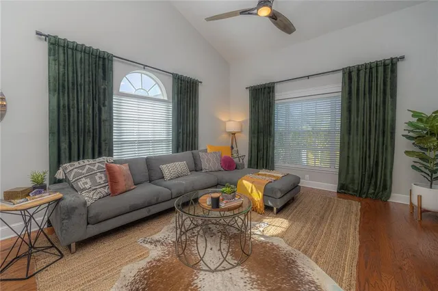 a living room with furniture a rug and a window