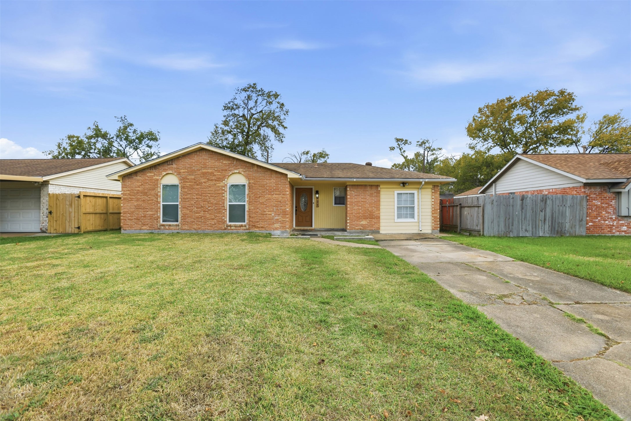 827 Parkhill Street Channelview, TX 77530 - Photo 1 of 26 a front view of a house with a garden and deck