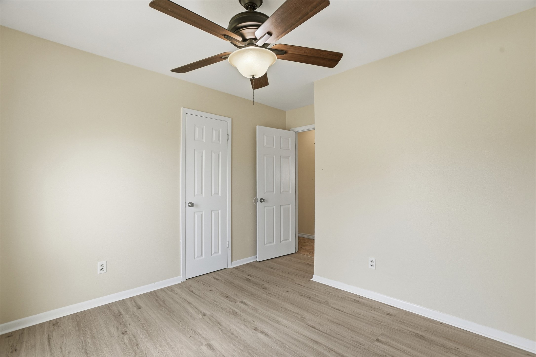827 Parkhill Street Channelview, TX 77530 - Photo 12 of 26 a view of an empty room with wooden floor
