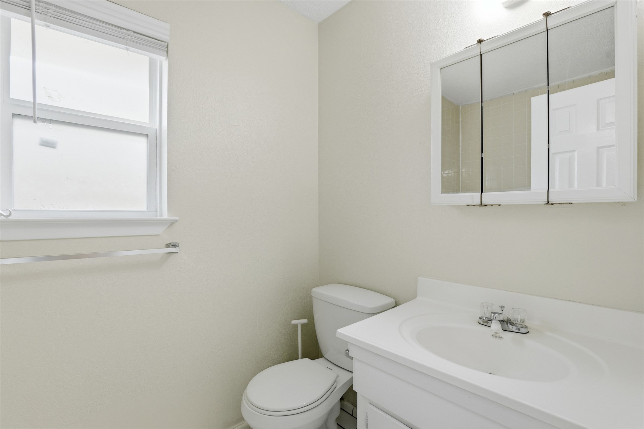827 Parkhill Street Channelview, TX 77530 - Photo 15 of 26 a white toilet sitting next to a bathroom sink