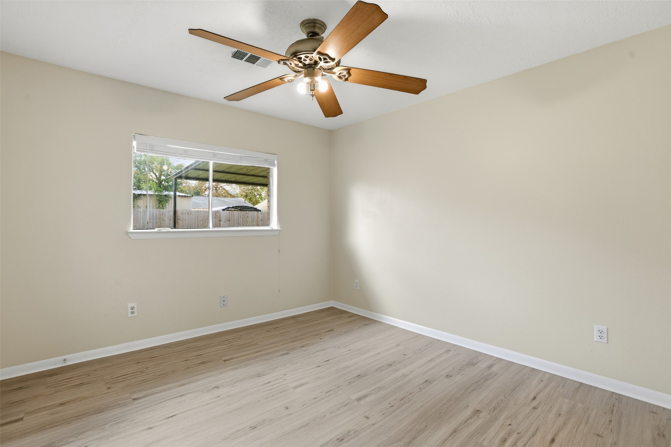 827 Parkhill Street Channelview, TX 77530 - Photo 18 of 26 a view of an empty room with wooden floor and a window