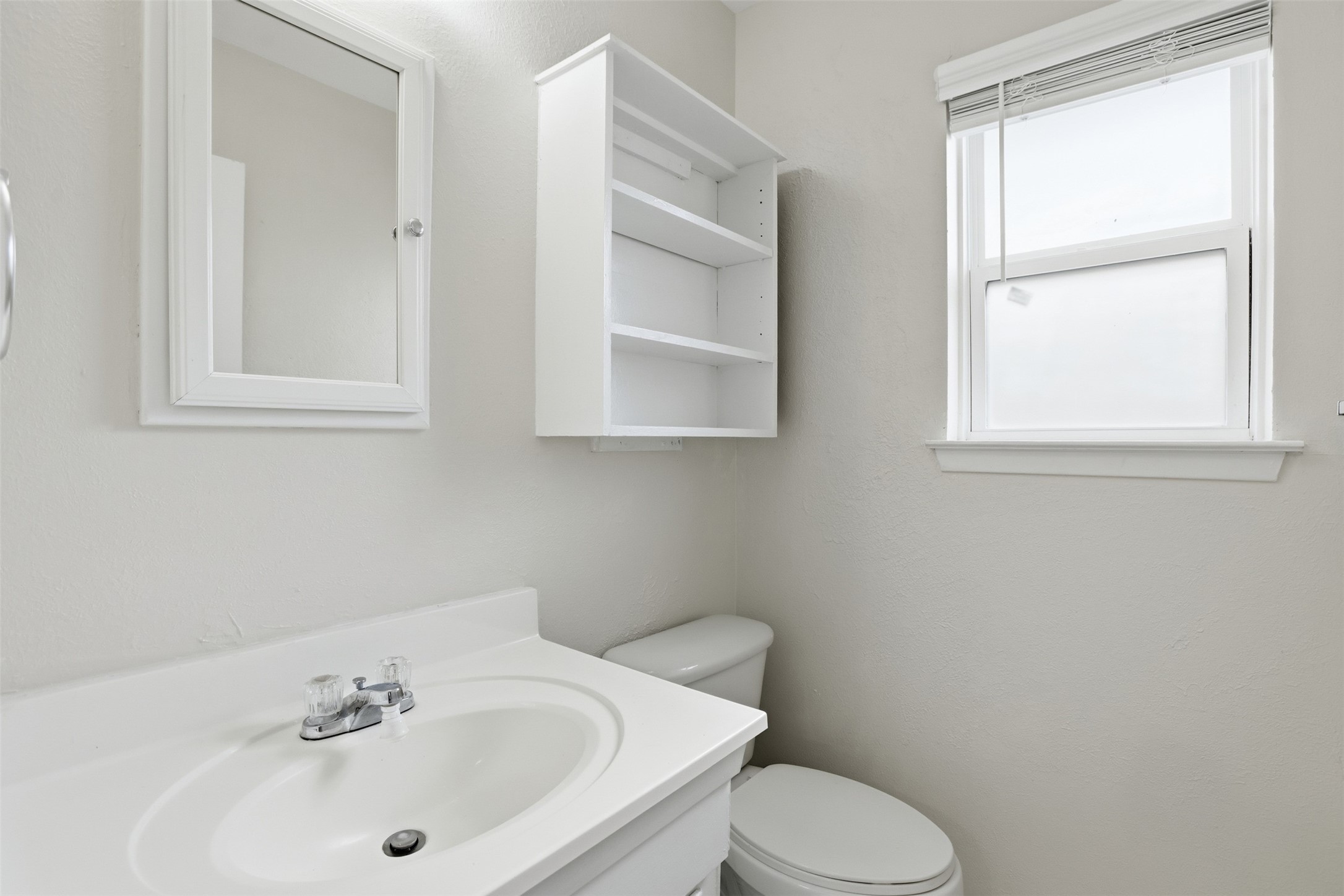 827 Parkhill Street Channelview, TX 77530 - Photo 20 of 26 a white toilet sitting next to a bathroom sink