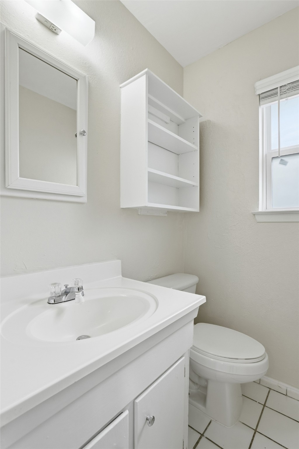 827 Parkhill Street Channelview, TX 77530 - Photo 21 of 26 a bathroom with a sink a toilet and a mirror