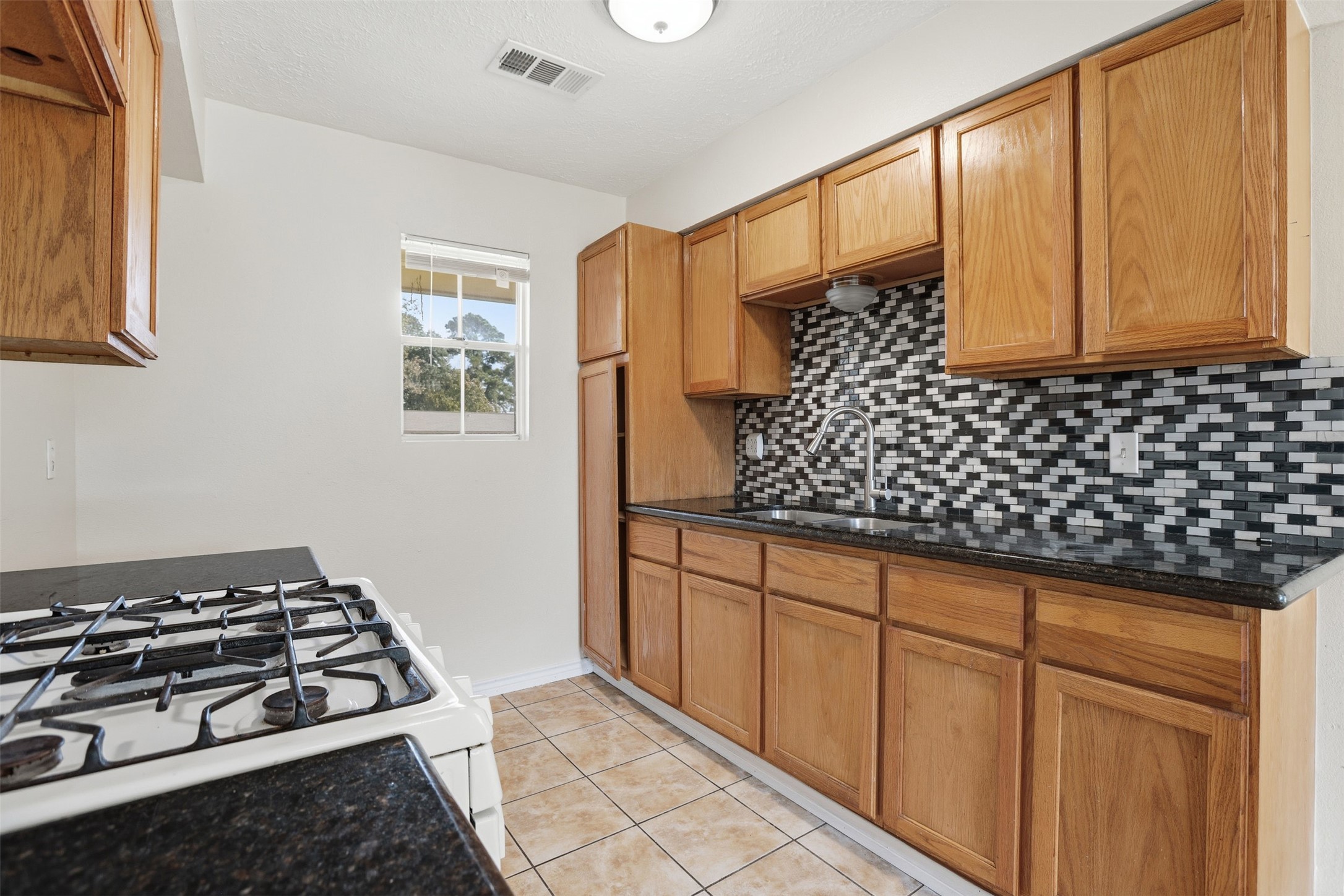 827 Parkhill Street Channelview, TX 77530 - Photo 9 of 26 a bathroom with a sink a toilet and a shower