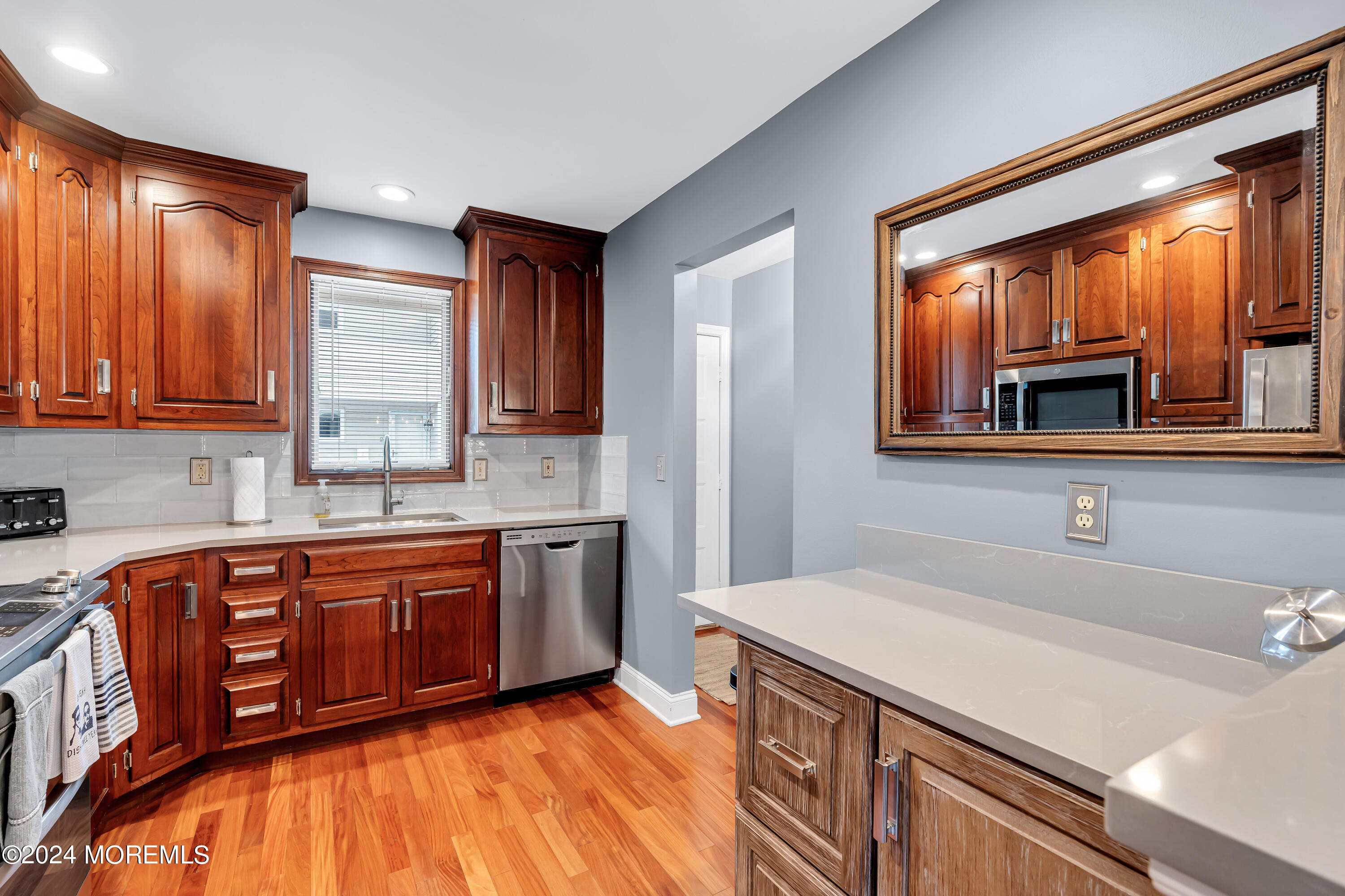 16 Spruce Lane Spring Lake Heights, NJ 07762 - Photo 11 of 31 a kitchen with wooden cabinets and a sink