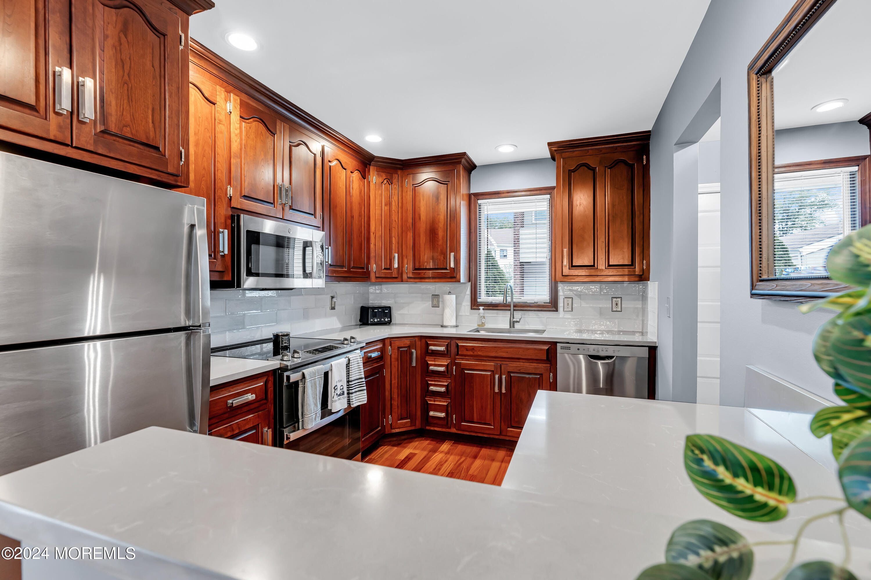 16 Spruce Lane Spring Lake Heights, NJ 07762 - Photo 12 of 31 a kitchen with stainless steel appliances granite countertop a refrigerator sink stove microwave and cabinets
