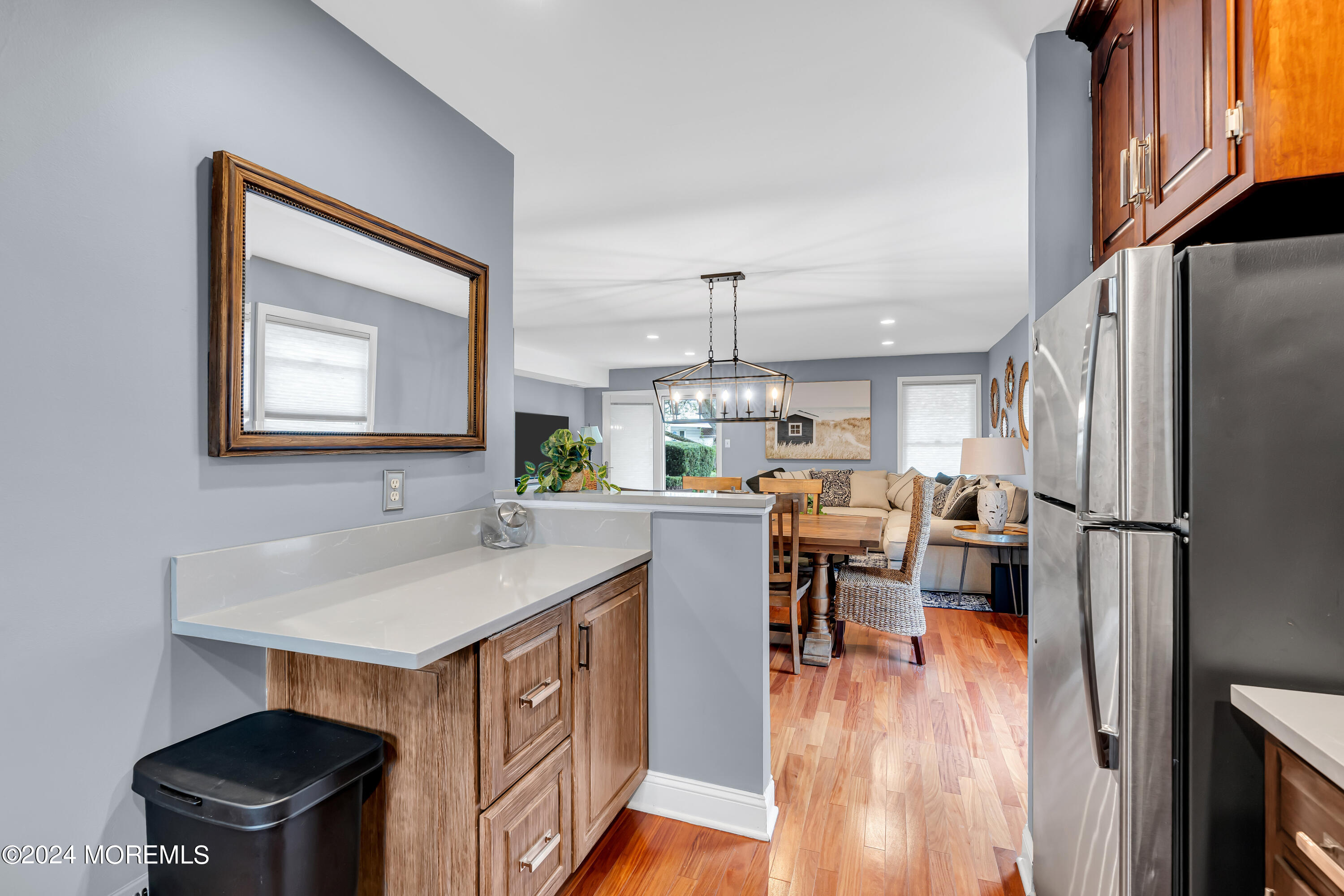 16 Spruce Lane Spring Lake Heights, NJ 07762 - Photo 13 of 31 a kitchen with a refrigerator a sink dishwasher a dining table and chairs with wooden floor