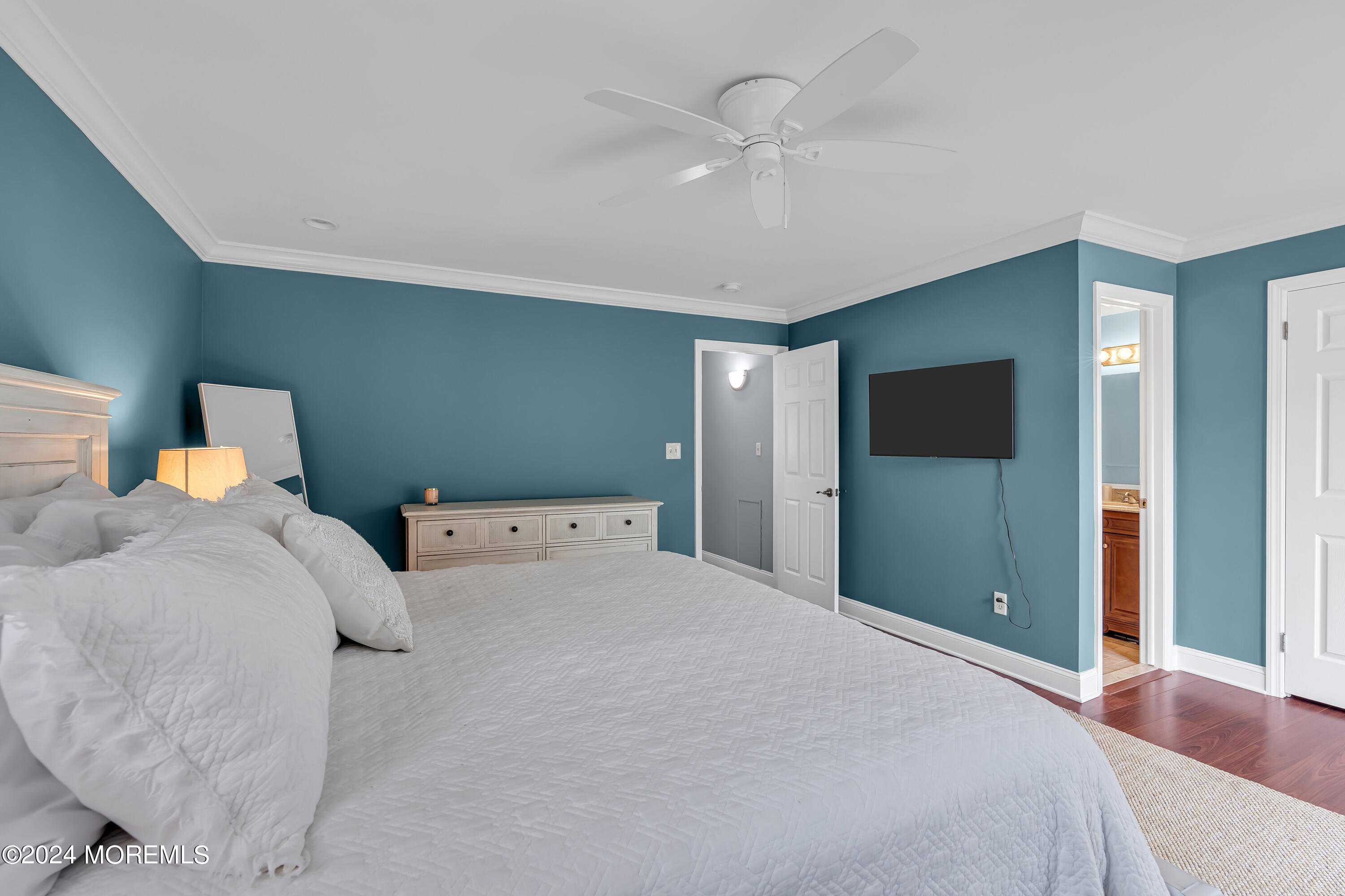 16 Spruce Lane Spring Lake Heights, NJ 07762 - Photo 20 of 31 a bedroom with a large bed and a chandelier