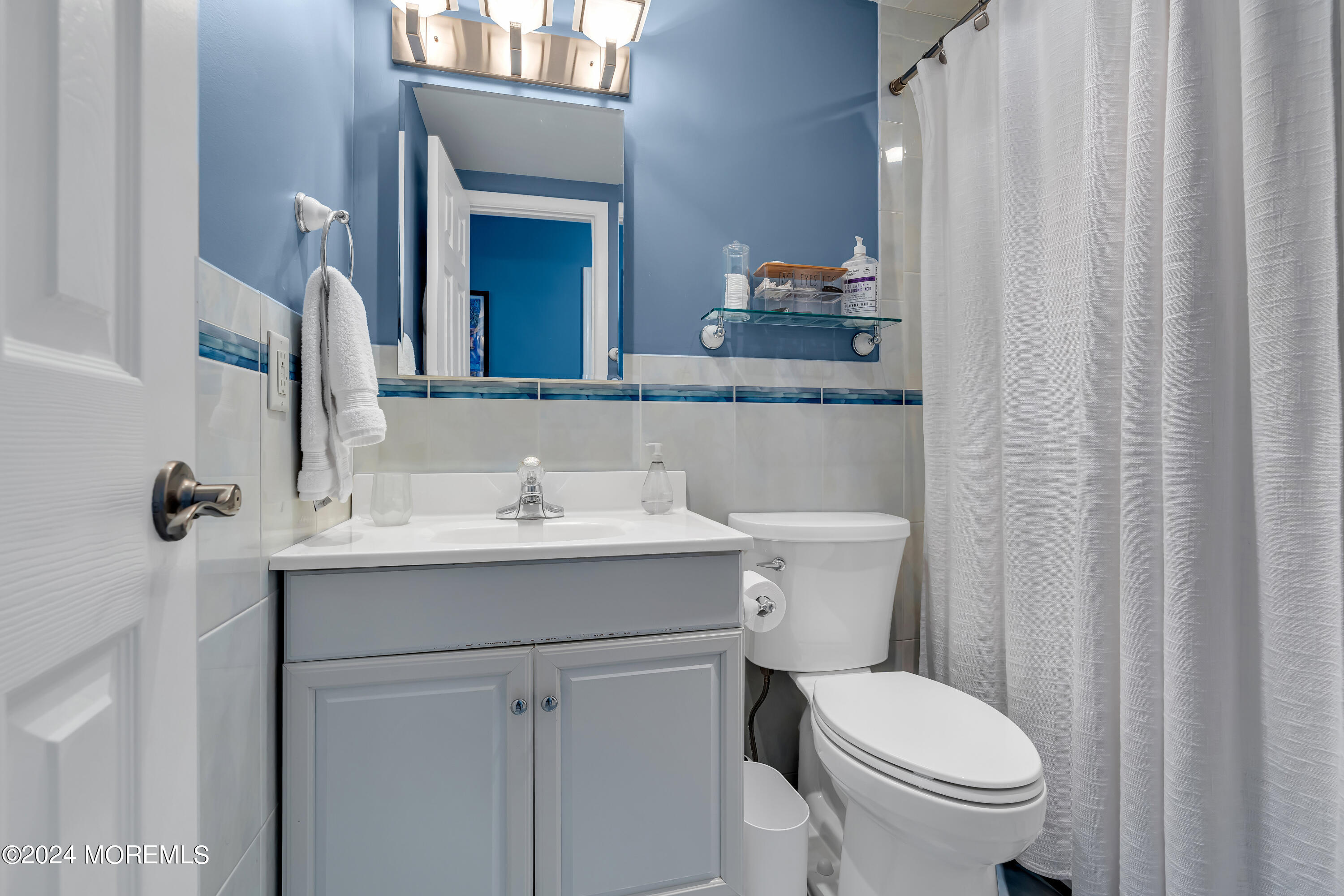 16 Spruce Lane Spring Lake Heights, NJ 07762 - Photo 27 of 31 a bathroom with a sink a toilet and a mirror