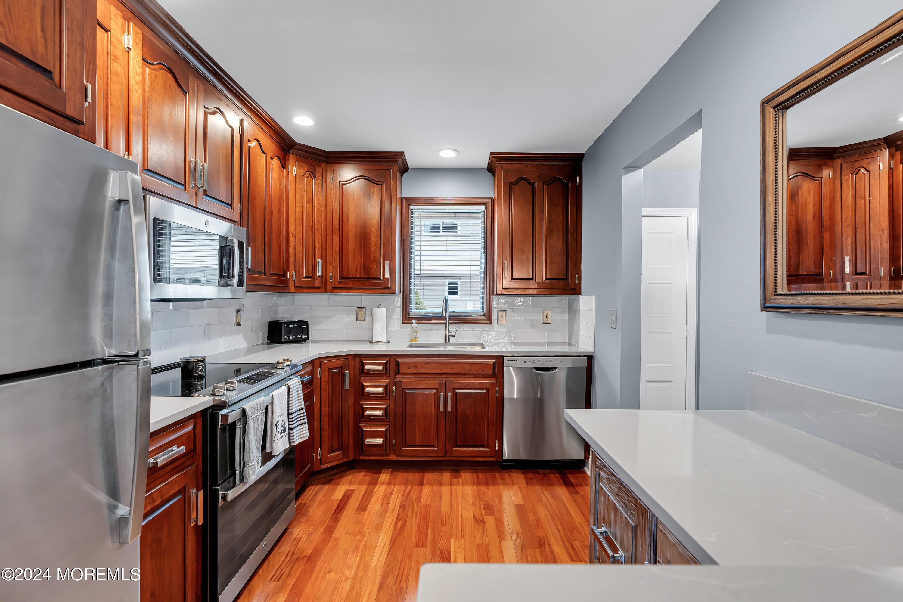 16 Spruce Lane Spring Lake Heights, NJ 07762 - Photo 10 of 31 a large kitchen with stainless steel appliances granite countertop a stove a sink dishwasher and a refrigerator