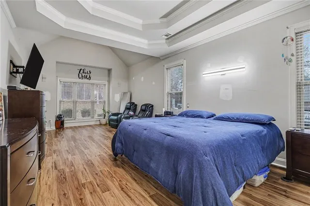 a bedroom with bed and flat screen tv