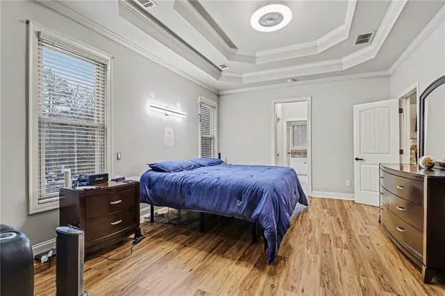 a spacious bedroom with a bed and a dresser