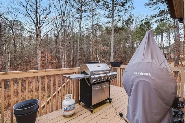 a view of a deck with furniture and wooden fence