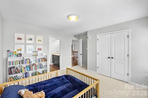 a view of an empty room with furniture and book shelf