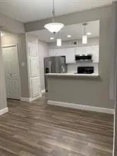 a view of kitchen with stainless steel appliances refrigerator and stove