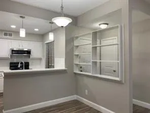 a kitchen with stainless steel appliances granite countertop a refrigerator a sink and a stove