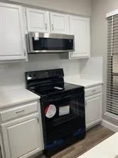 a stove top oven sitting inside of a kitchen