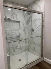 a bathroom with a glass shower door