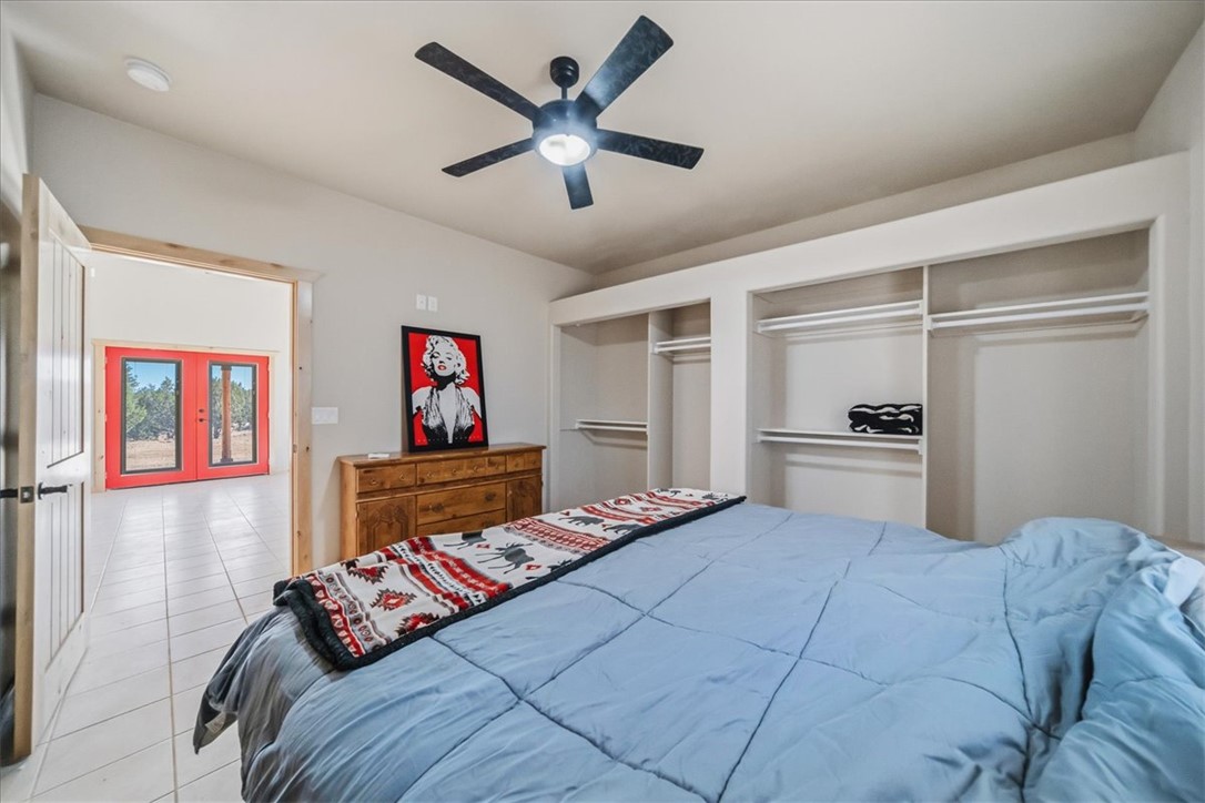 10374 East Happy Trails Road Kingman, AZ 86401 - Photo 29 of 68 a bedroom with a bed and a chandelier