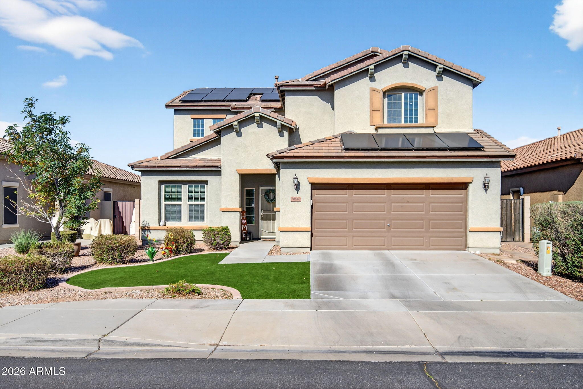 10840 West Saddlehorn Road Peoria, AZ 85383 - Photo 1 of 55 a front view of a house with a yard and garage