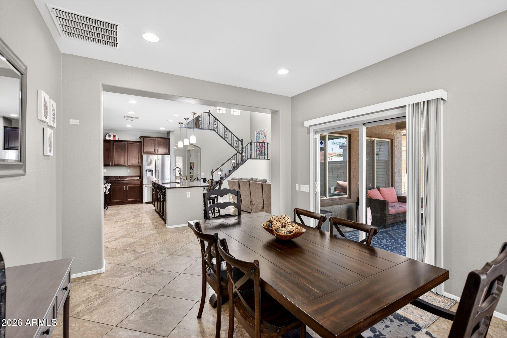 10840 West Saddlehorn Road Peoria, AZ 85383 - Photo 13 of 55 a view of a dining room and livingroom with furniture wooden floor a chandelier