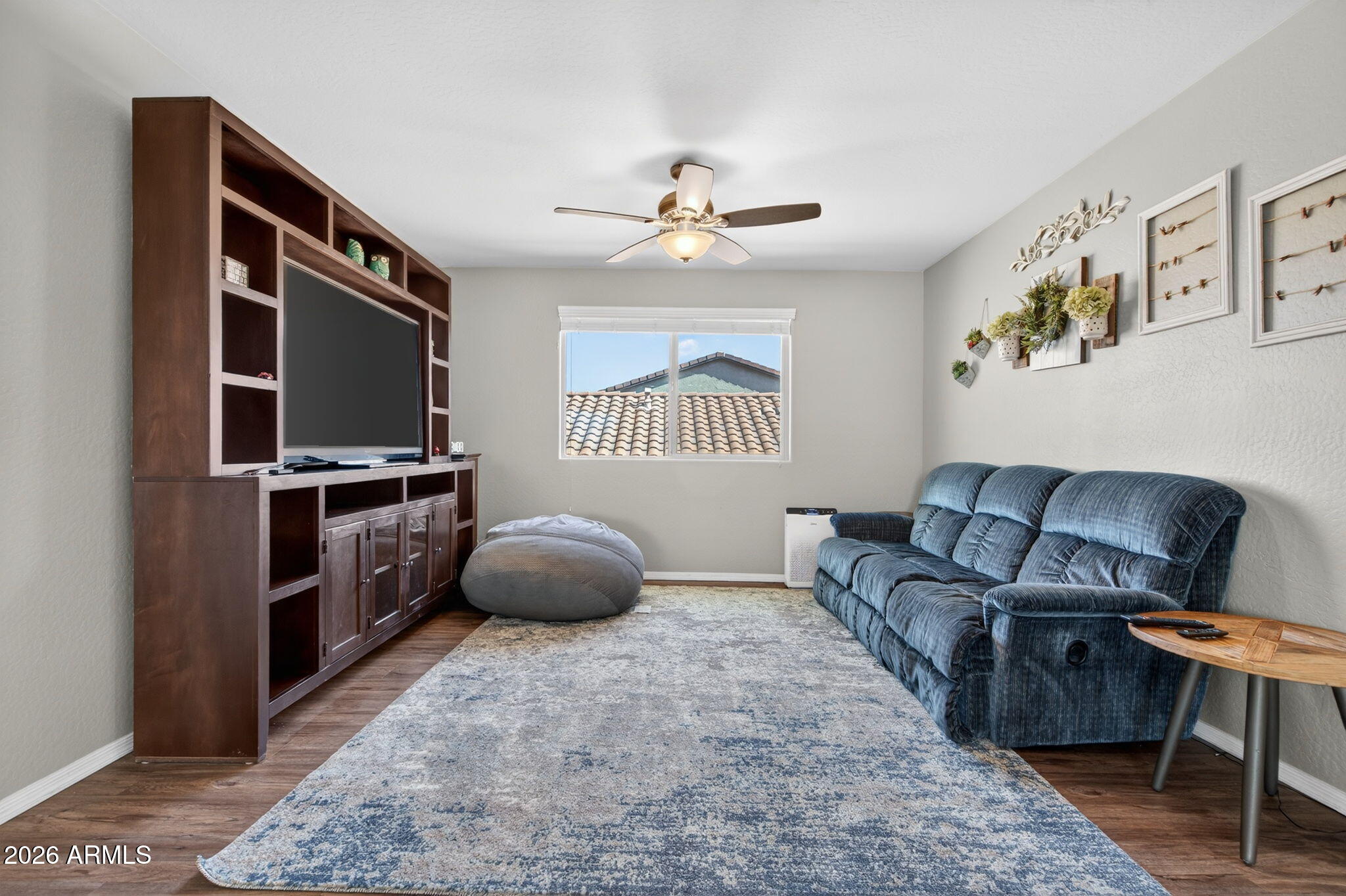 10840 West Saddlehorn Road Peoria, AZ 85383 - Photo 18 of 55 a living room with furniture and a flat screen tv