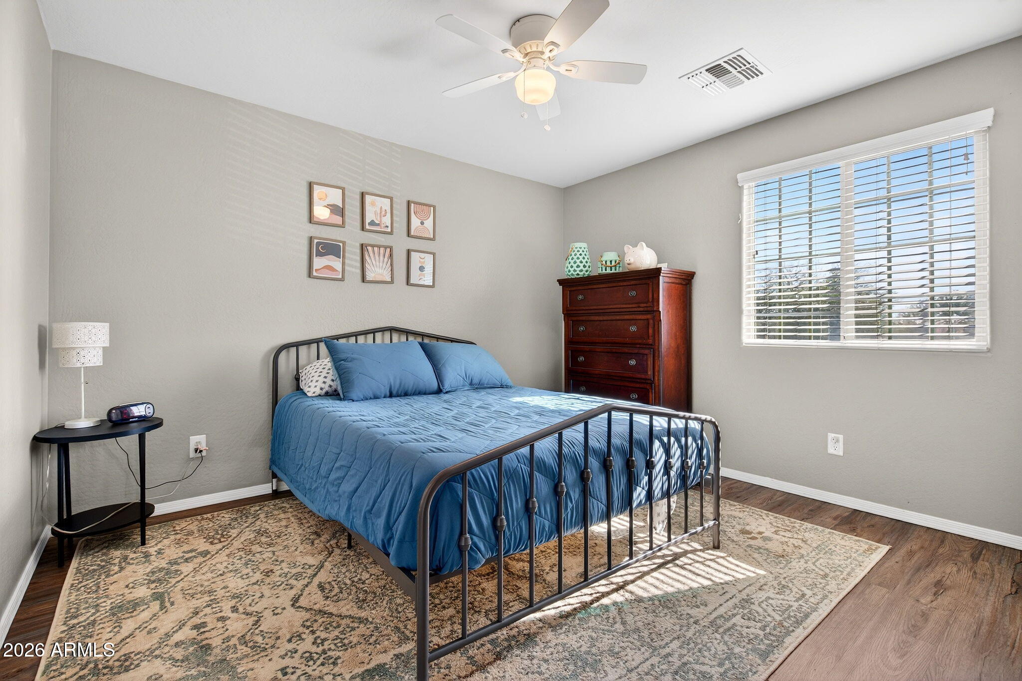 10840 West Saddlehorn Road Peoria, AZ 85383 - Photo 25 of 55 a bedroom with a bed and wooden floor
