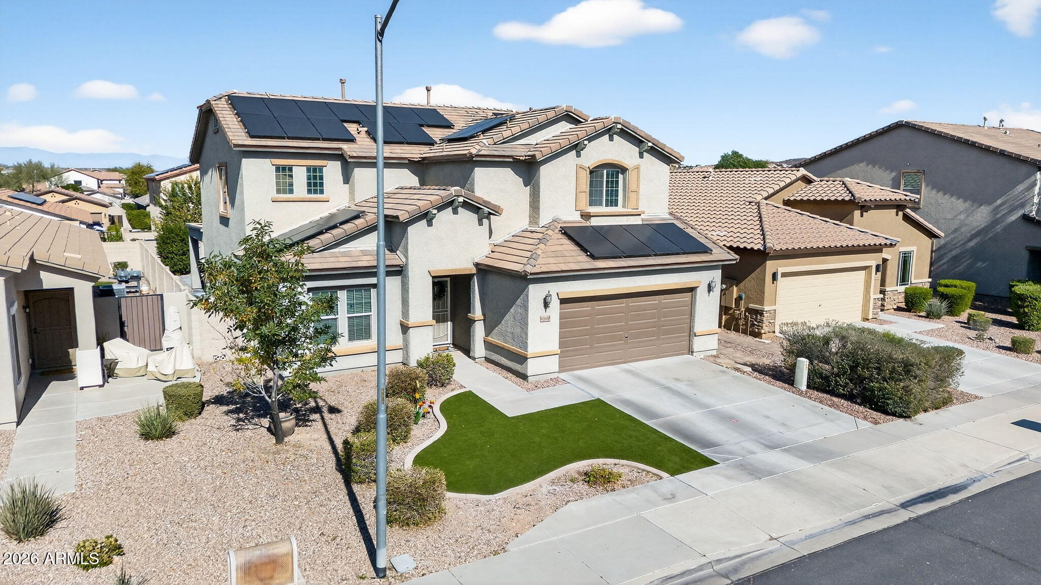 10840 West Saddlehorn Road Peoria, AZ 85383 - Photo 44 of 55 a front view of a house with a yard and garage