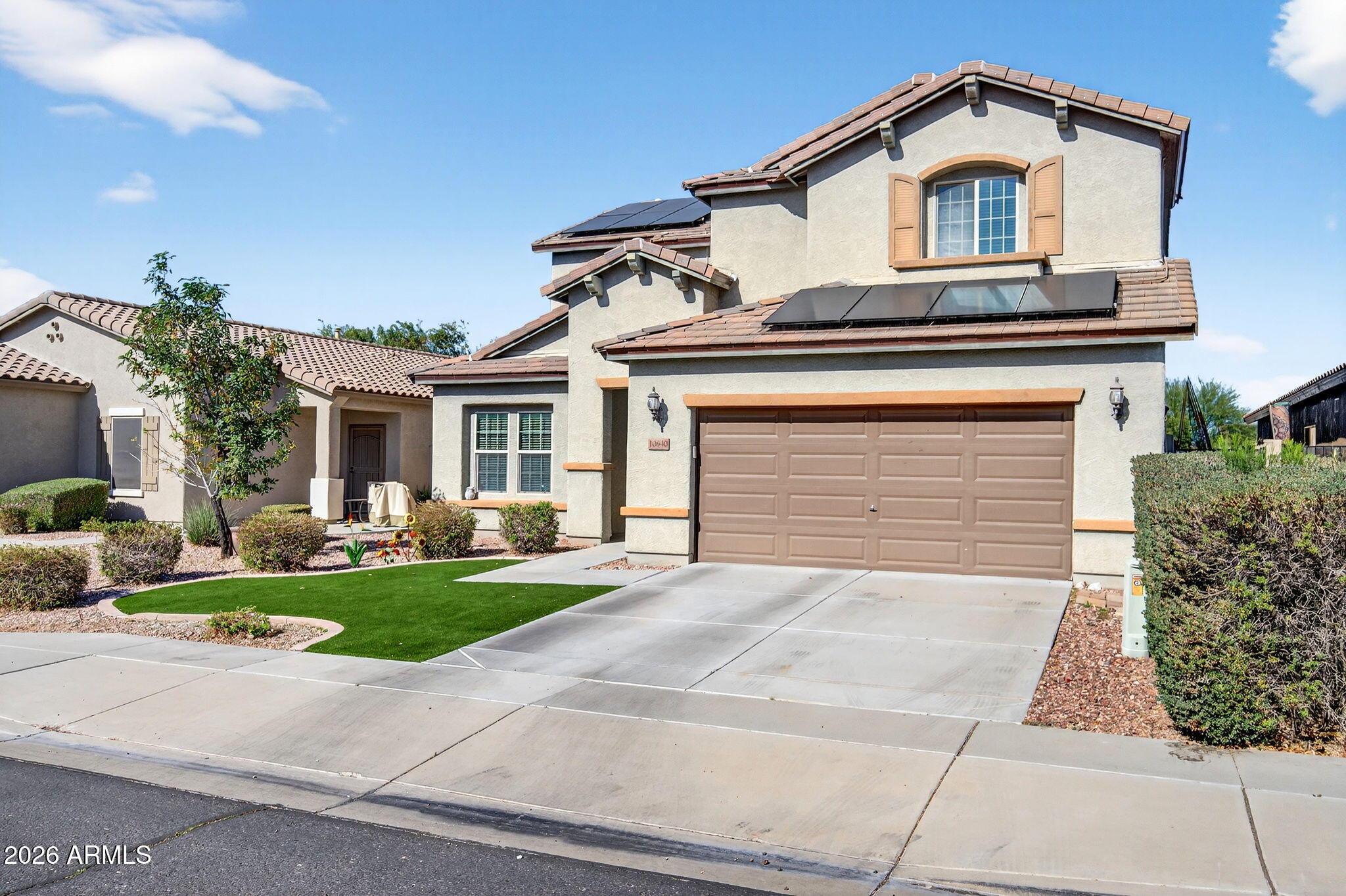 10840 West Saddlehorn Road Peoria, AZ 85383 - Photo 3 of 55 a front view of a house with a yard and garage