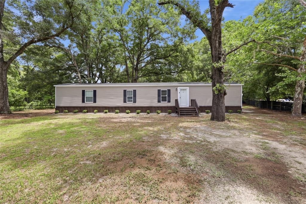 215 Southwest Alpine Place High Springs, FL 32643 - Photo 2 of 41 a house view with a garden space