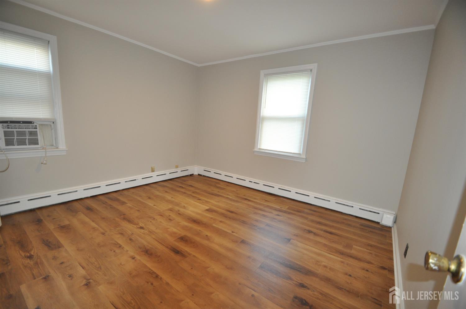 213 Old Post Road Edison, NJ 08817 - Photo 11 of 18 an empty room with wooden floor and windows