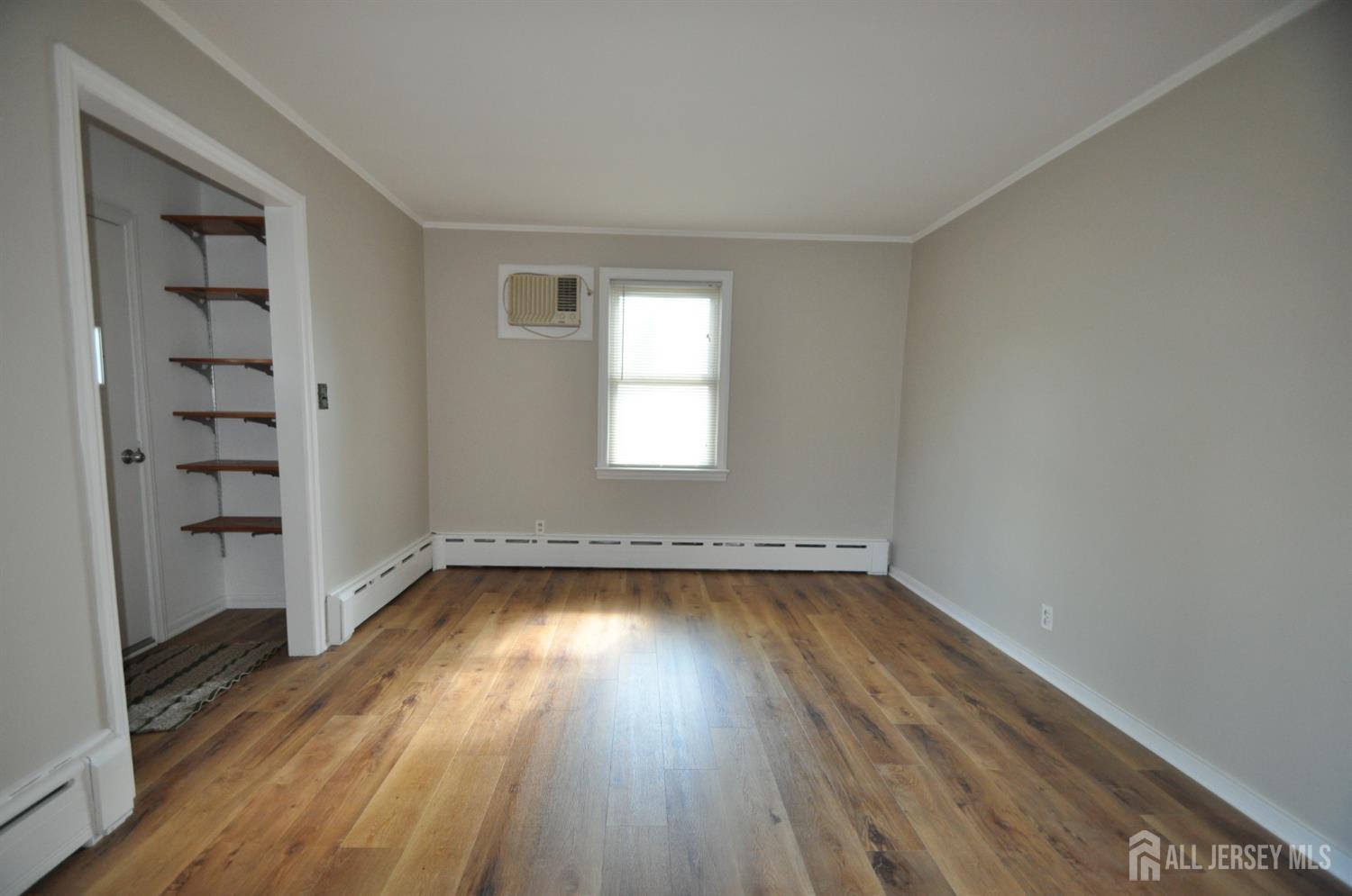 213 Old Post Road Edison, NJ 08817 - Photo 7 of 18 an empty room with wooden floor and window