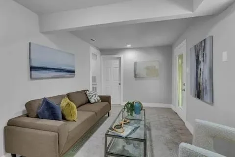 a living room with furniture and a potted plant