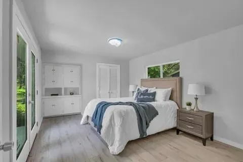 a bed room with a bed and a large window