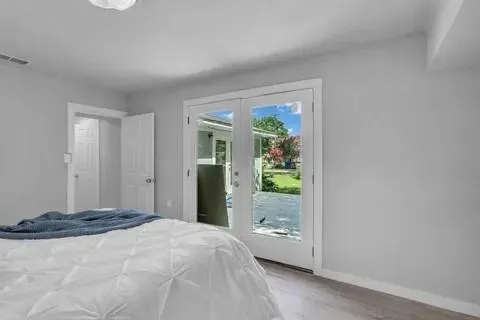 a bedroom with a bed and a window
