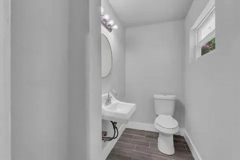 a white toilet sitting next to a white sink